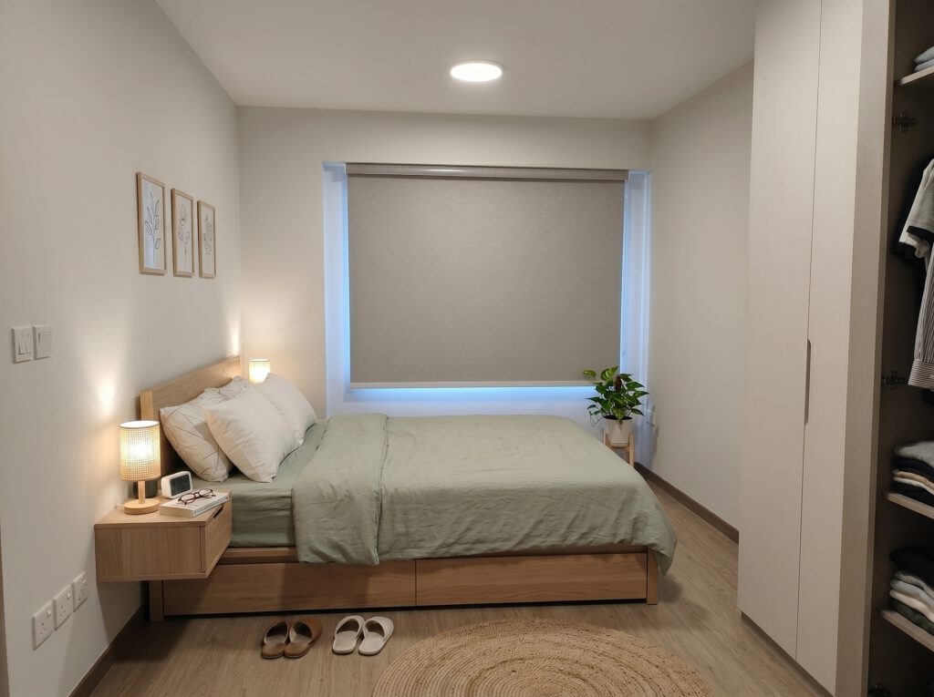 Blackout roller blind fully closed in a master bedroom of a Sengkang HDB flat Singapore, complete darkness blocking 100% sunlight for deep restful sleep