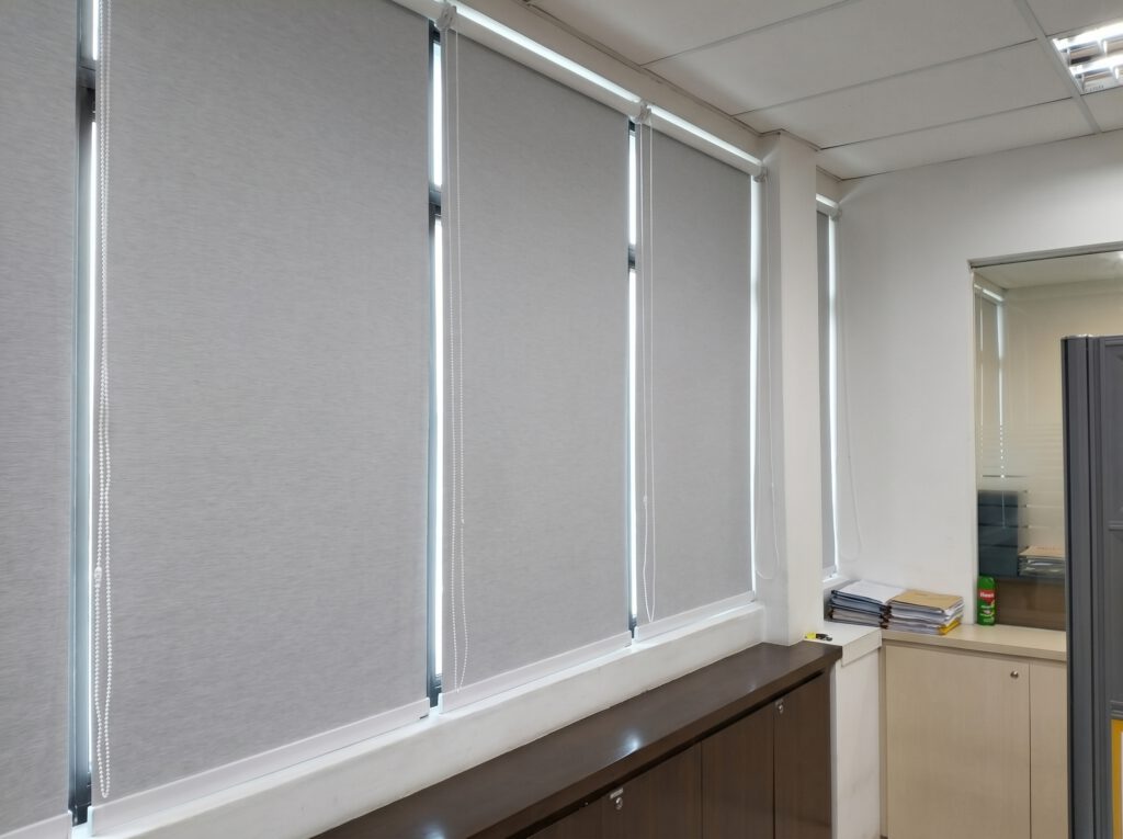 Blackout roller blind fully drawn in a corporate office meeting room in Tanjong Pagar Singapore CBD, complete light blockage for projector presentations