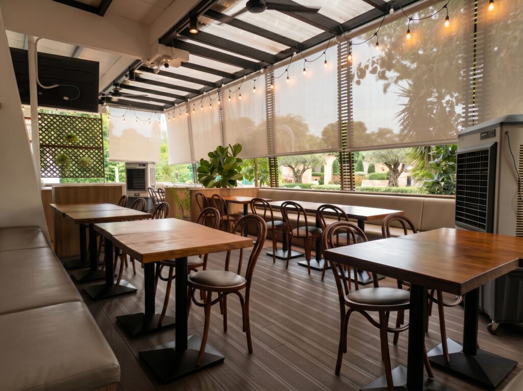 Outdoor blinds providing shade and weather protection for a dining space in Singapore.