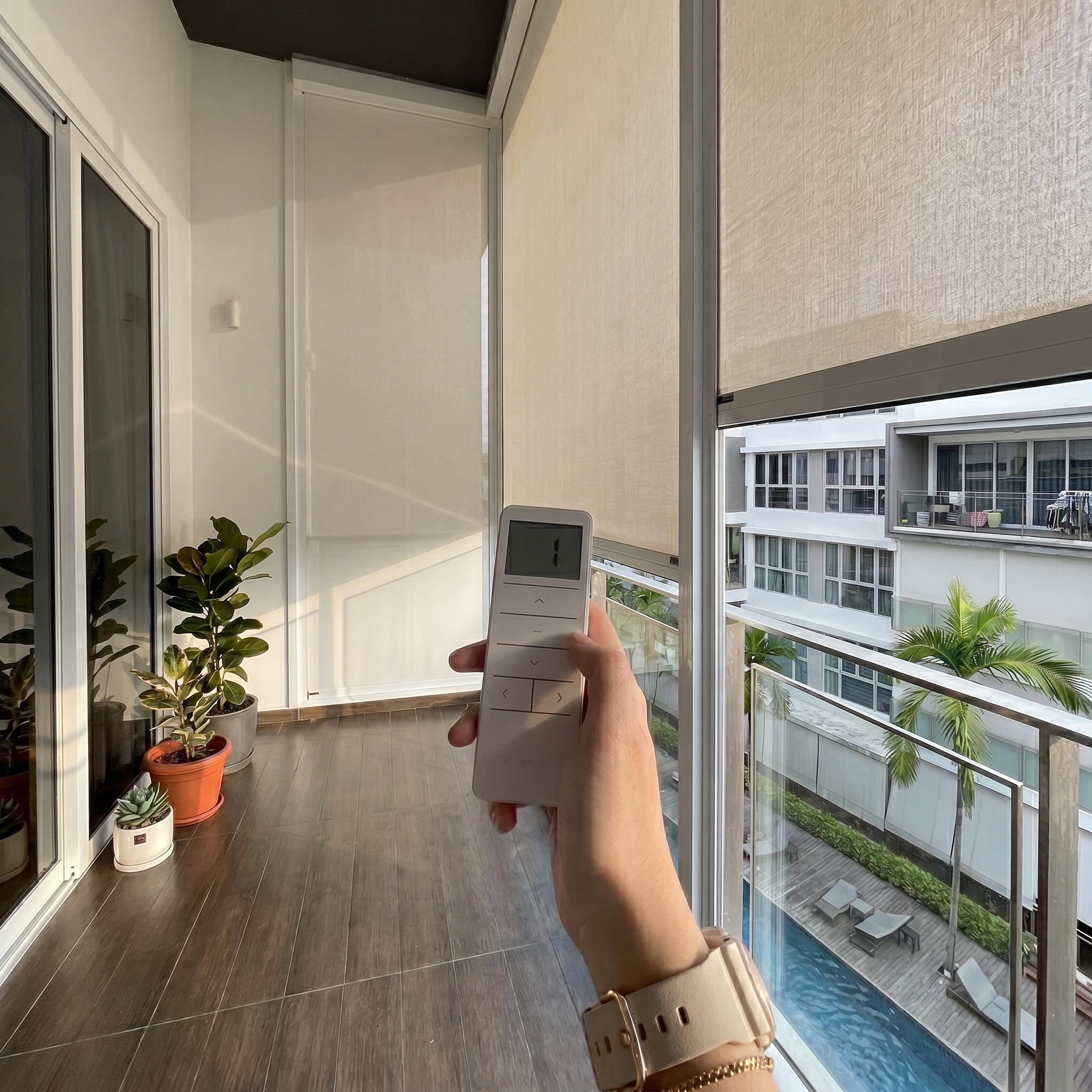Motorised ZipScreen installed at One Bernam condo balcony in Singapore with remote control.