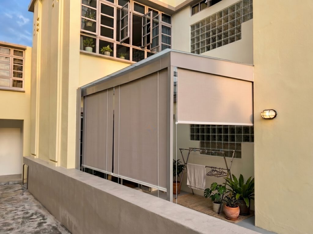 Outdoor blinds installed around a landed house patio for privacy, shade and weather protection.