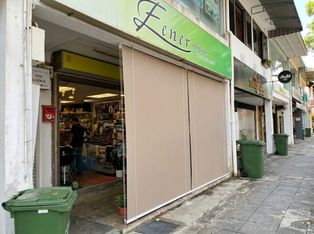 Outdoor blinds installed at a Singapore shopfront for shade and weather protection.