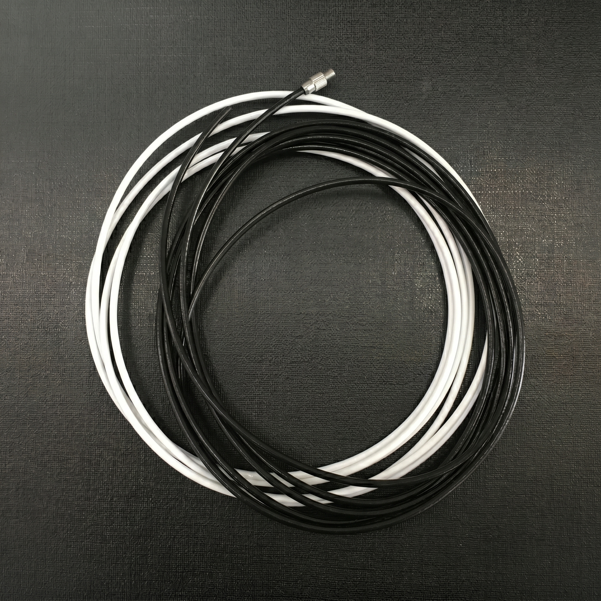 Stainless steel cable side guide used to support outdoor blinds in windy environments.