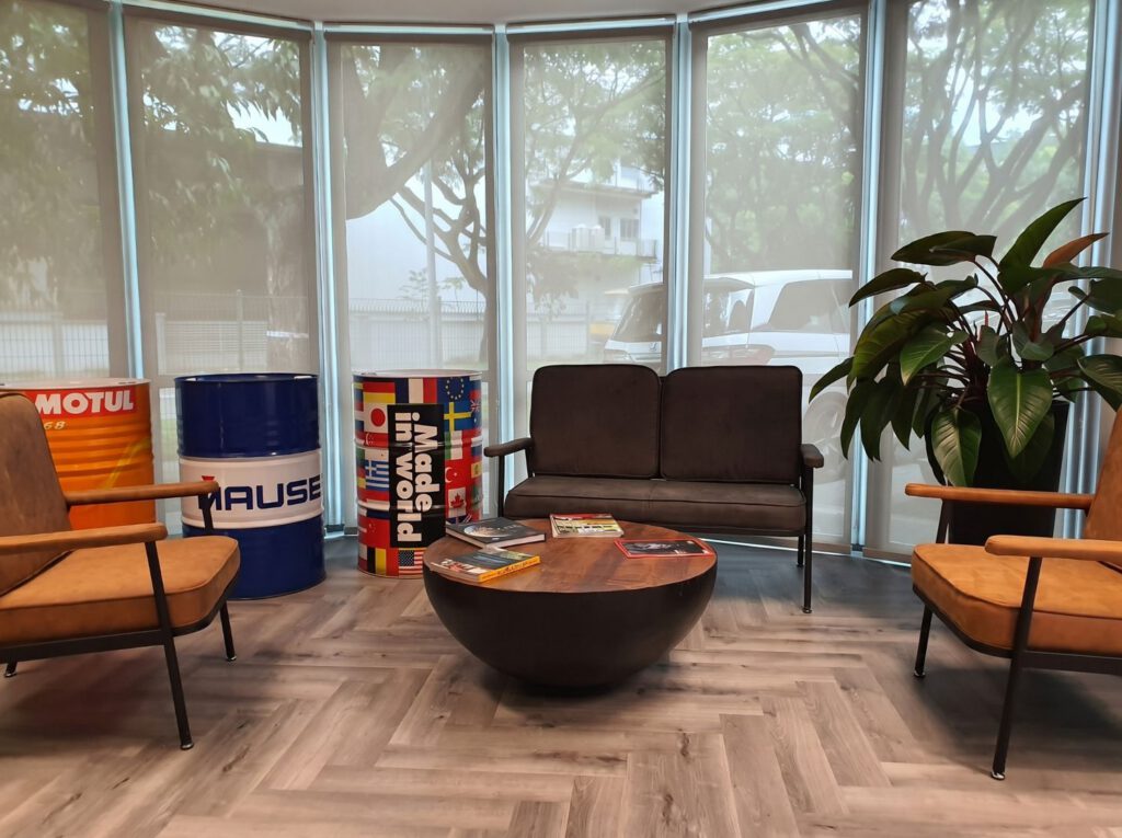 Sunscreen roller blinds on large glass office windows in one-north Singapore, 5% openness mesh fabric reducing UV glare and solar heat while keeping outside view