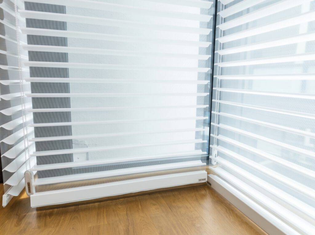Close-up of Trishade blinds showing 3 layer fabric vanes for soft light control in Singapore homes.