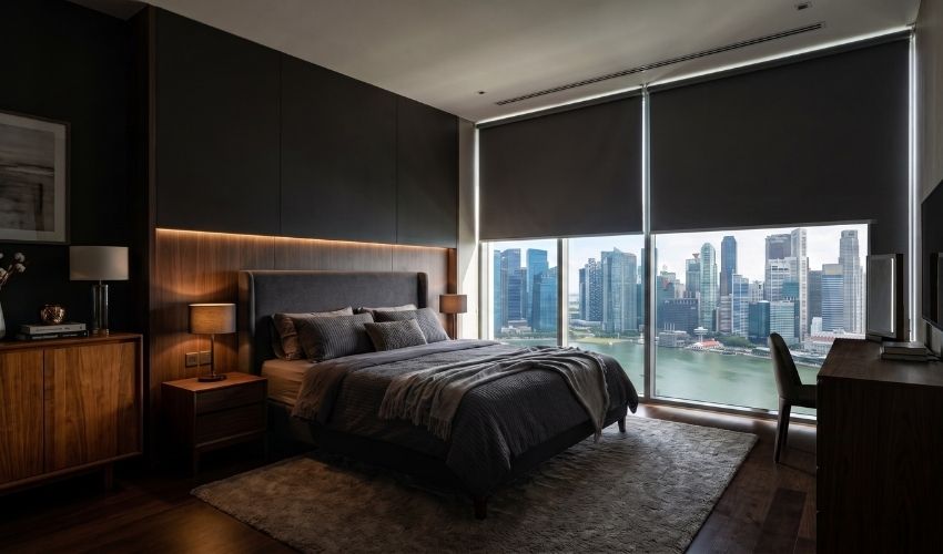 Blackout roller blinds installed inside a Singapore bedroom for better privacy.