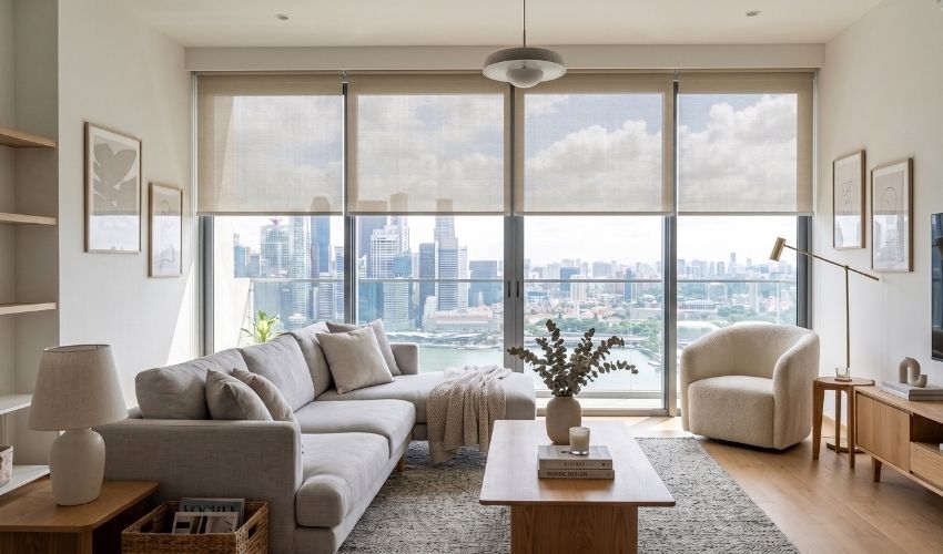 Sunscreen roller blinds installed in a modern Singapore living room.