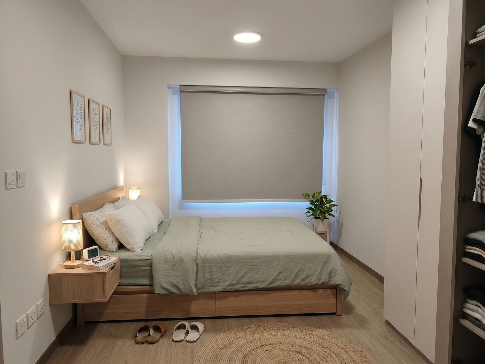 Blackout roller blind fully closed in a master bedroom of a Sengkang HDB flat Singapore, complete darkness blocking 100% sunlight for deep restful sleep