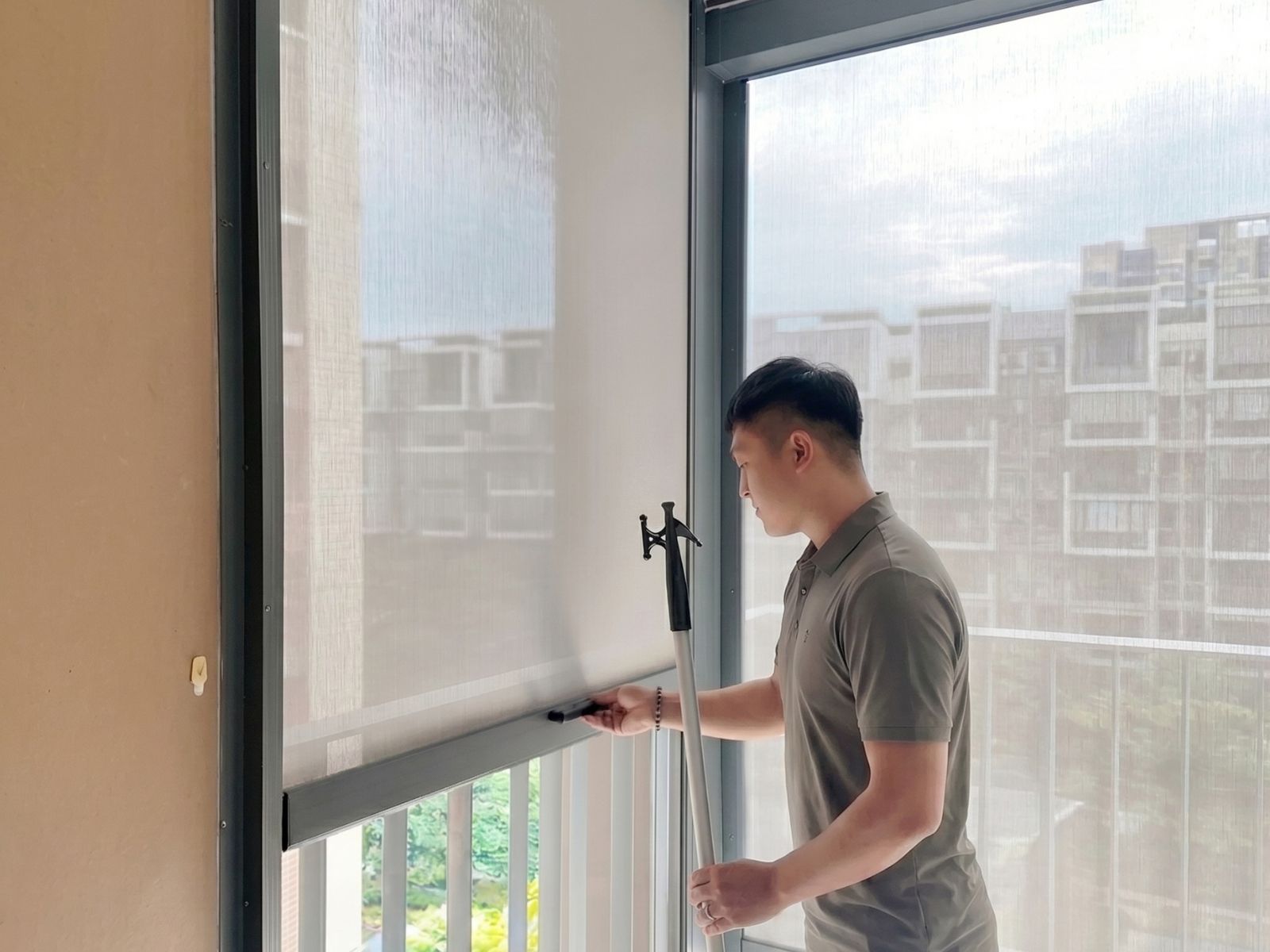 Manual zip blind operated with a pull stick at The Tapestry condo in Singapore.