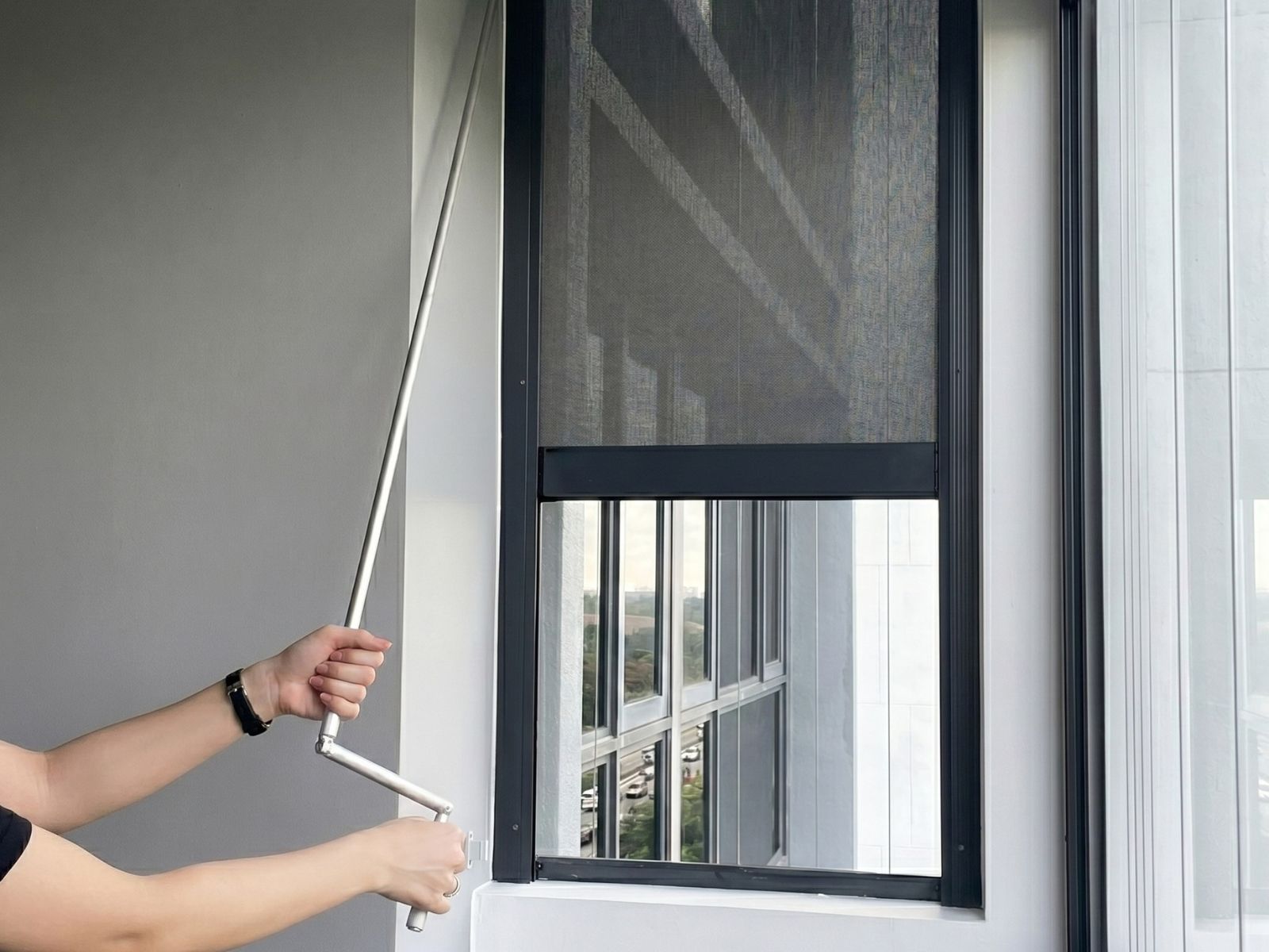 Manual outdoor zip screen with crank system installed at Punggol HDB.