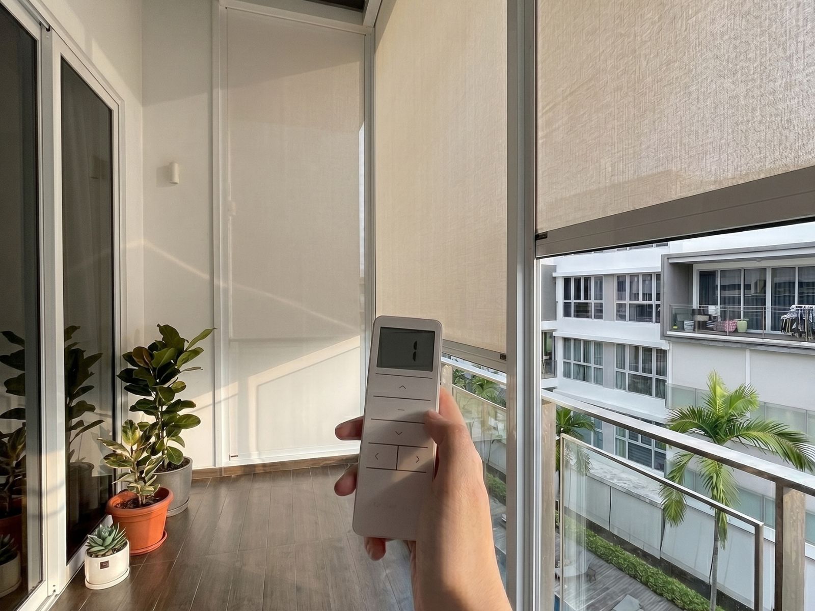 Motorised ZipScreen installed at One Bernam condo balcony in Singapore with remote control.