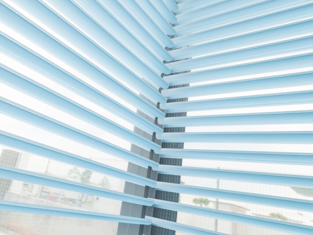 VB Blind 3-layer Trishade Blinds in Singapore, featuring light blue horizontal fabric vanes between sheer layers for adjustable daylight and privacy.