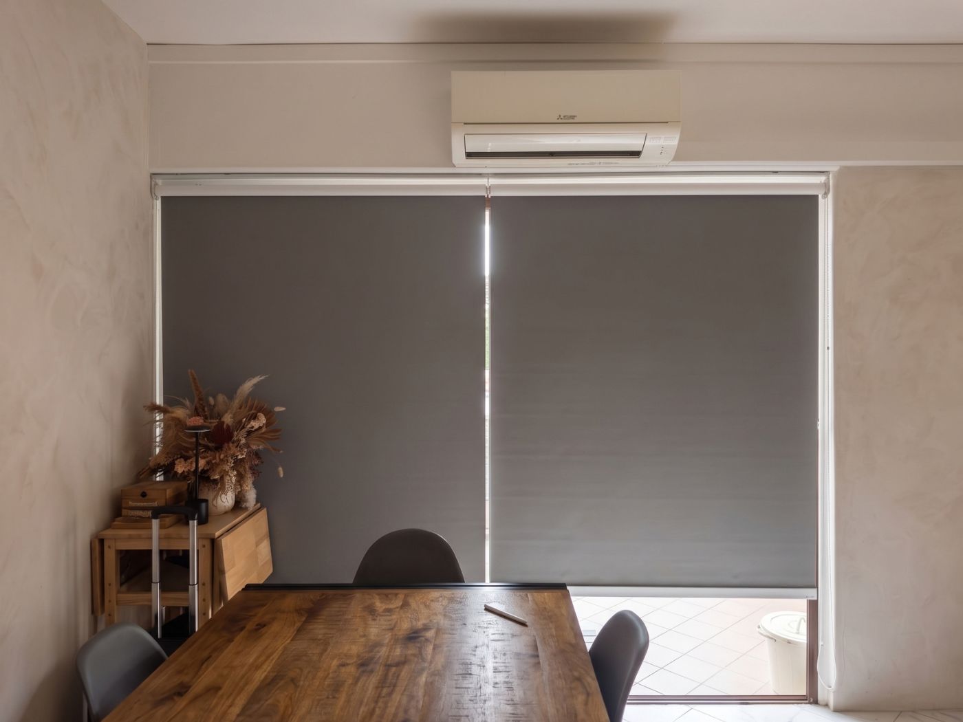 VB Blind grey roller blinds installed over large windows in a Singapore home dining area