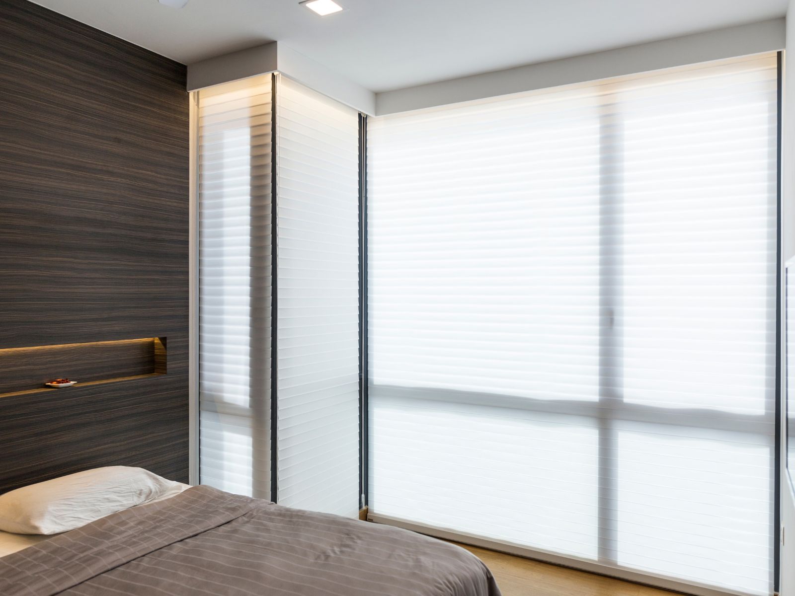 White VB Blind Trishade Shangri-La blinds covering corner bedroom windows, softly diffusing natural daylight.